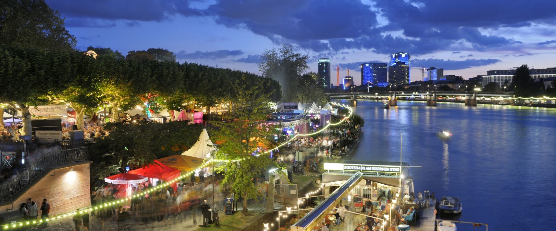 View of Frankfurt at night - the Mainuferweg on the left and the Main on the right.