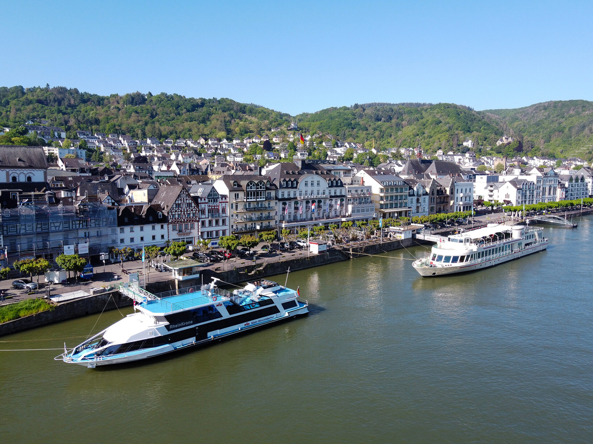 View of the ships MS RheinKrone and MS Asbach on the Middle Rhine. Both ships are moored at landing stages.