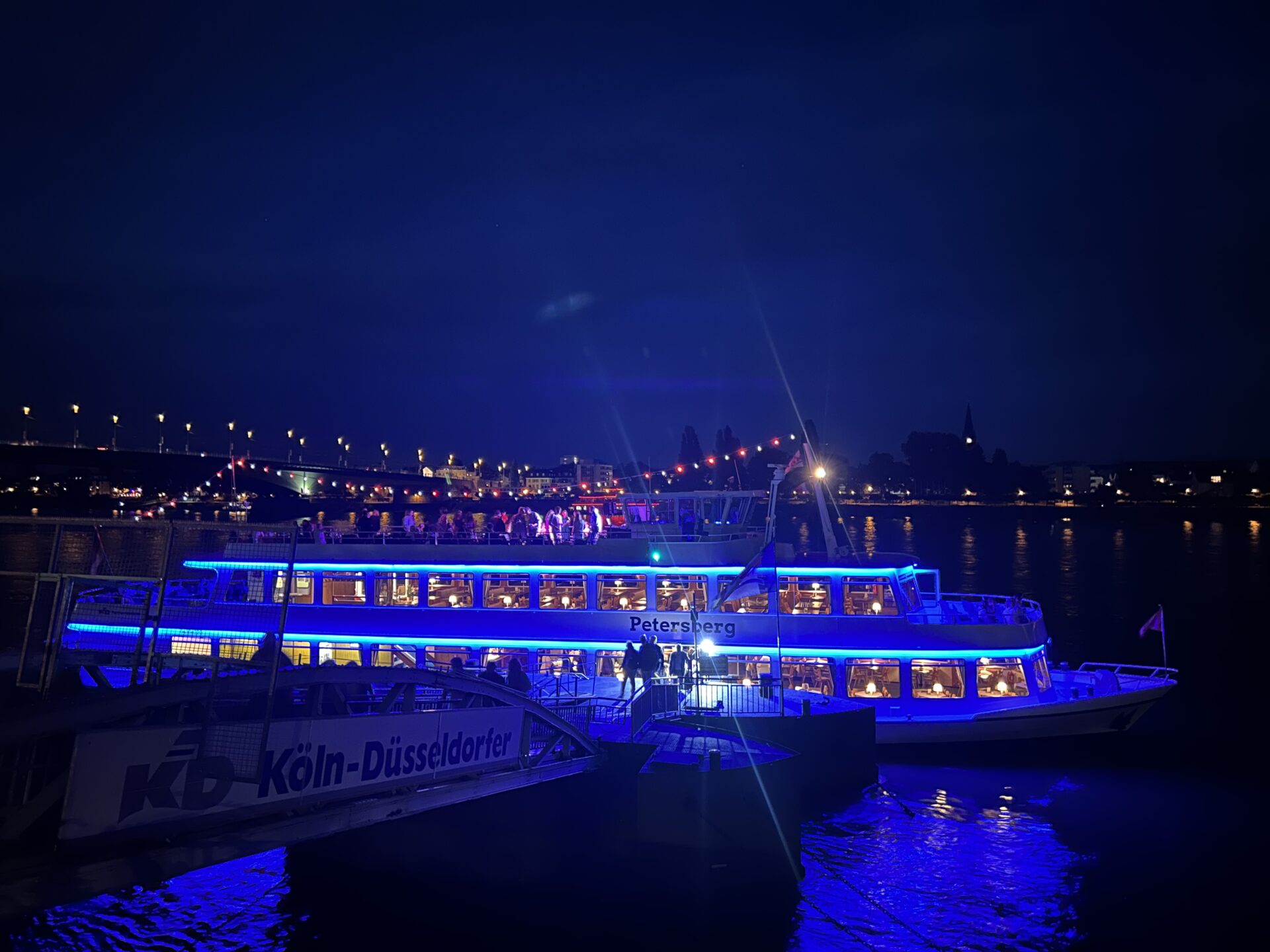 Schiff MS Petersberg auf dem Rhein im Dunklen blau beleuchtet