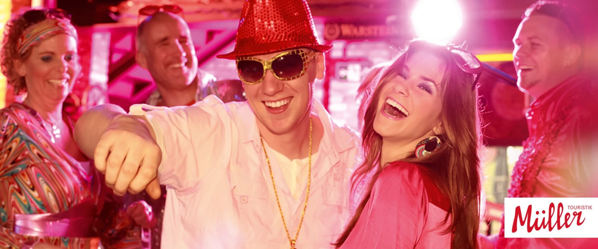 A couple in pop clothing at a party, three other people in the background