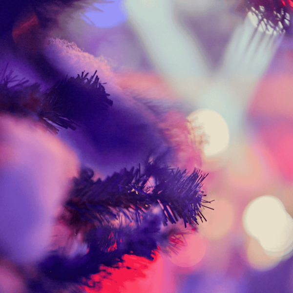 Spotlights on a blurred background, fir tree with artificial snow