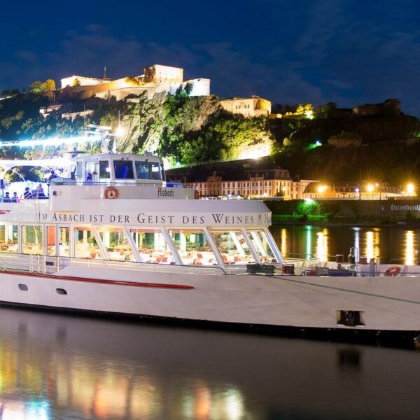The illuminated MS Asbach in front of Ehrenbreitstein Fortress in Koblenz