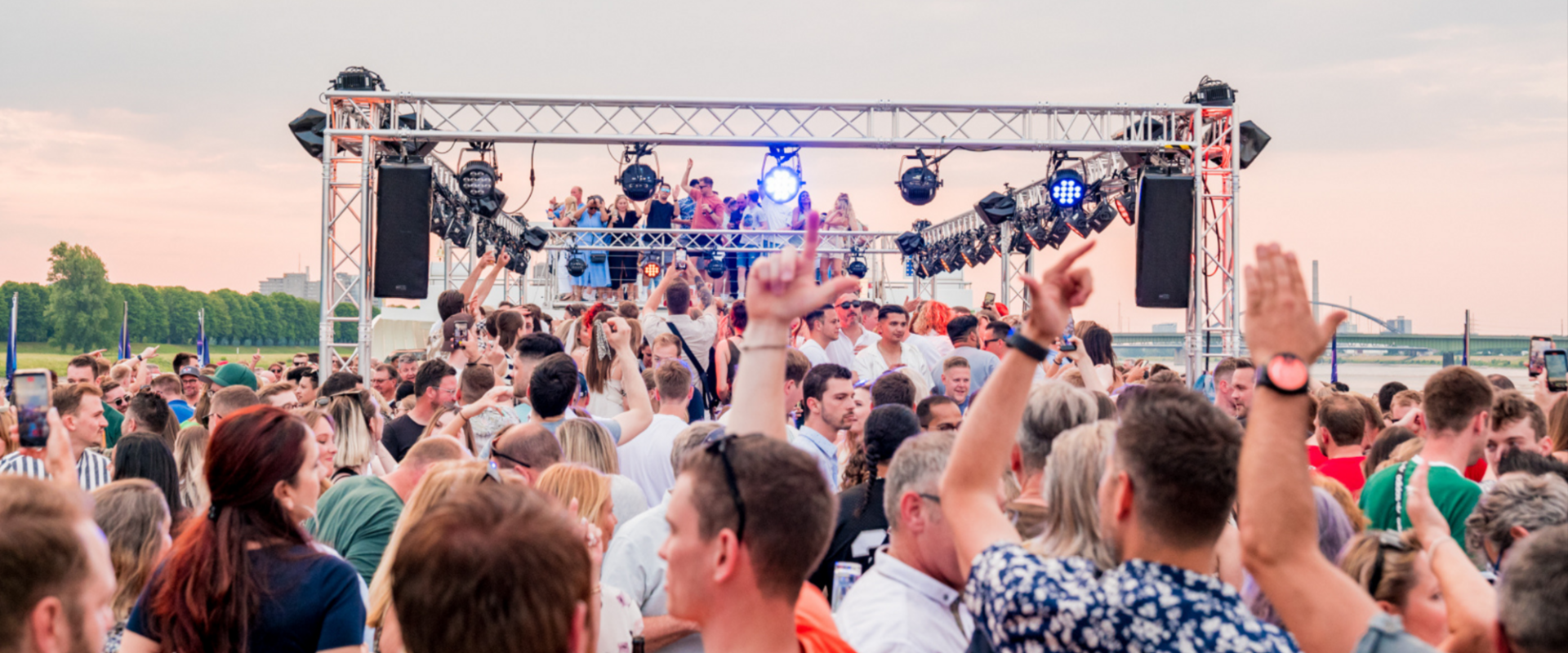 View of people celebrating on the open deck at sunset.