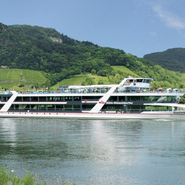Liner cruises on the Rhine. MS RheinFantasie on the Rhine in front of rocks and vineyards