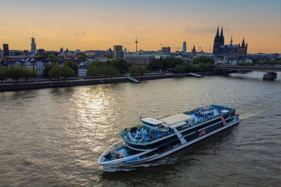 MS RheinFantasie auf dem Rhein in Köln bei Sonnenuntergang, im Hintergrund der Dom und die Altstadtpromenade