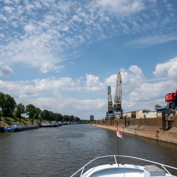 Schiff auf Rhein, rechts Kräne im Bild