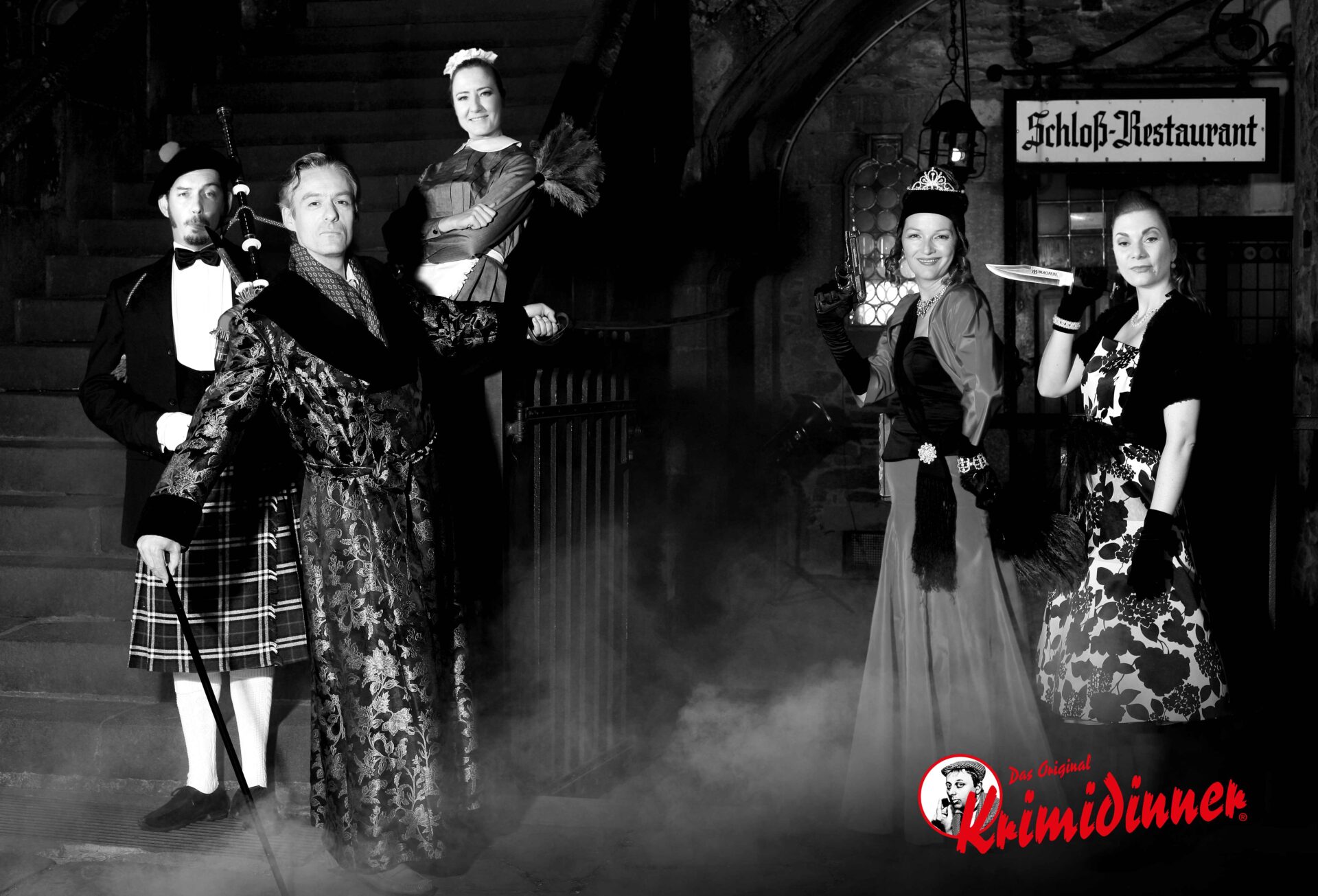 Two men and three women stand in the castle restaurant in disguise and hold weapons in their hands - fitting for a murder mystery dinner